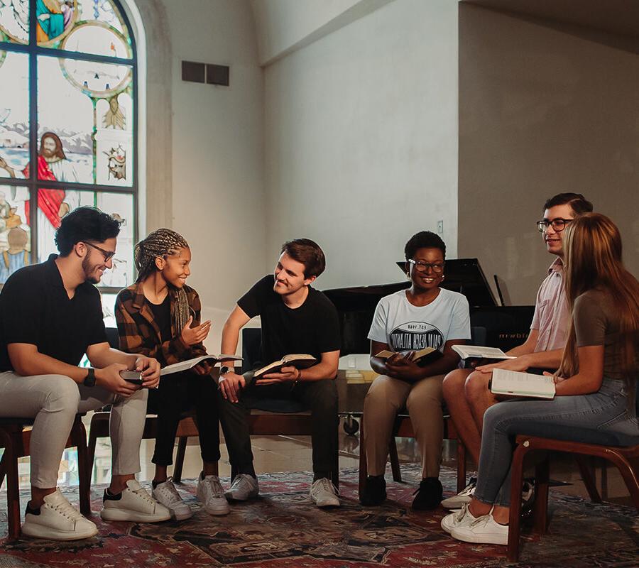 Christian Studies and Community Development students read together in a chapel.